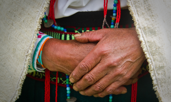 Indigenous woman with hands crossed in front of her